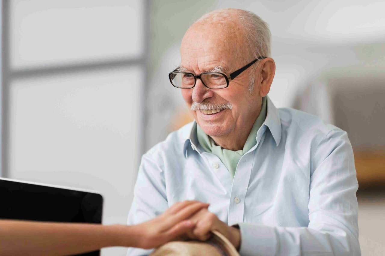 A caregiver and an older adult talking together